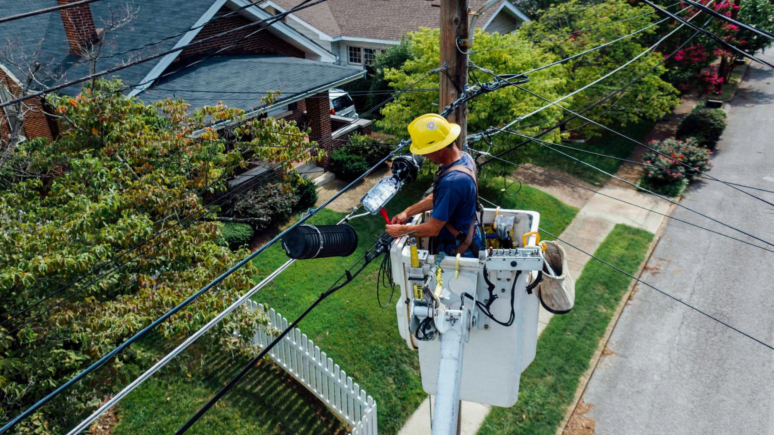 An electrician working on an electric pole.