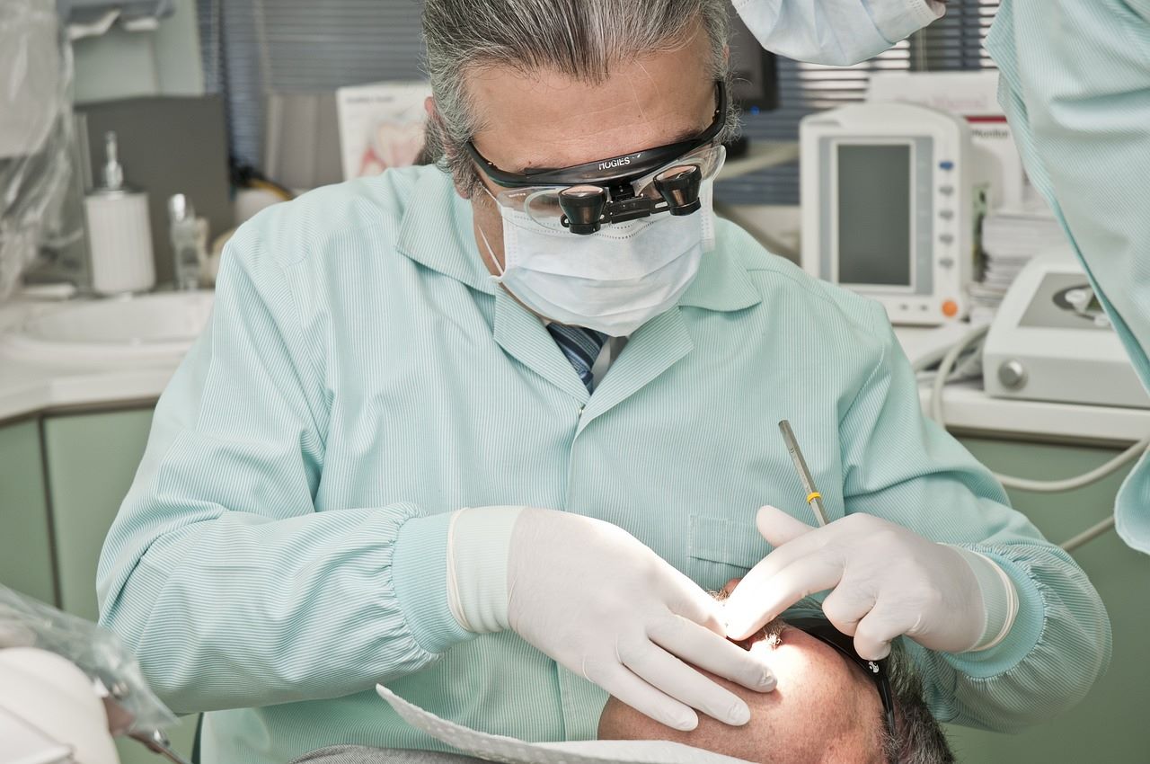 A dental professional attends to a patient in a modern dental office, highlighting the importance of oral health care.