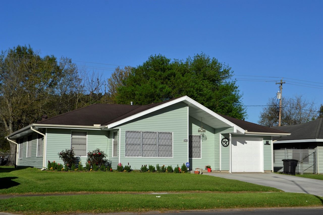 A house in a suburban area, with blue sky in the background.