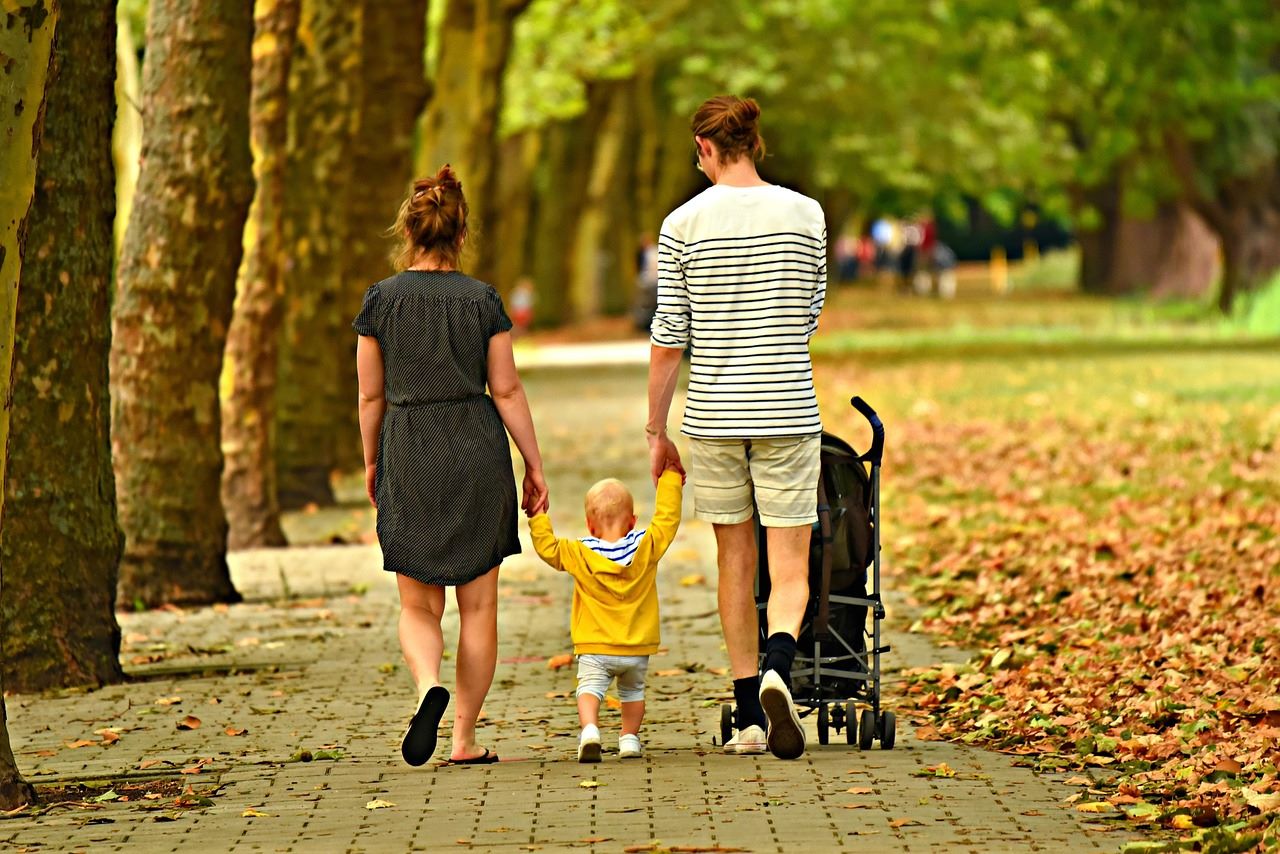 A family walks in the park, enjoying life in the best suburbs for families in Melbourne with EverLend Mortgage Brokers' help.